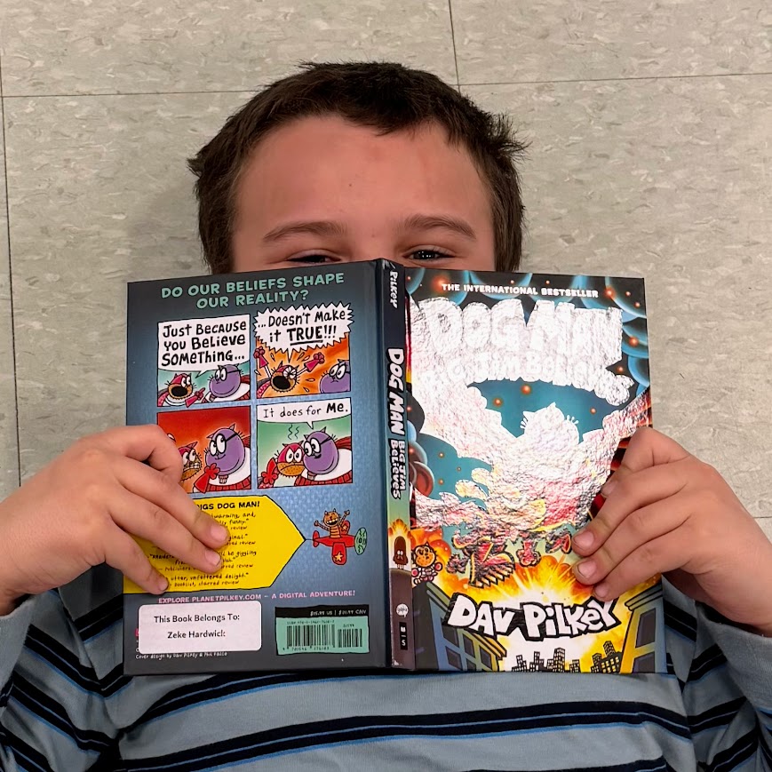 A student reads their new book. 